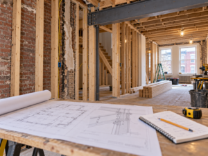 Stamped architectural and engineering plans laid out on a table at a Philadelphia construction site.