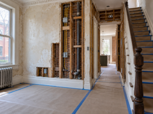 Selective demolition during a Philadelphia rowhome renovation with wall framing exposed